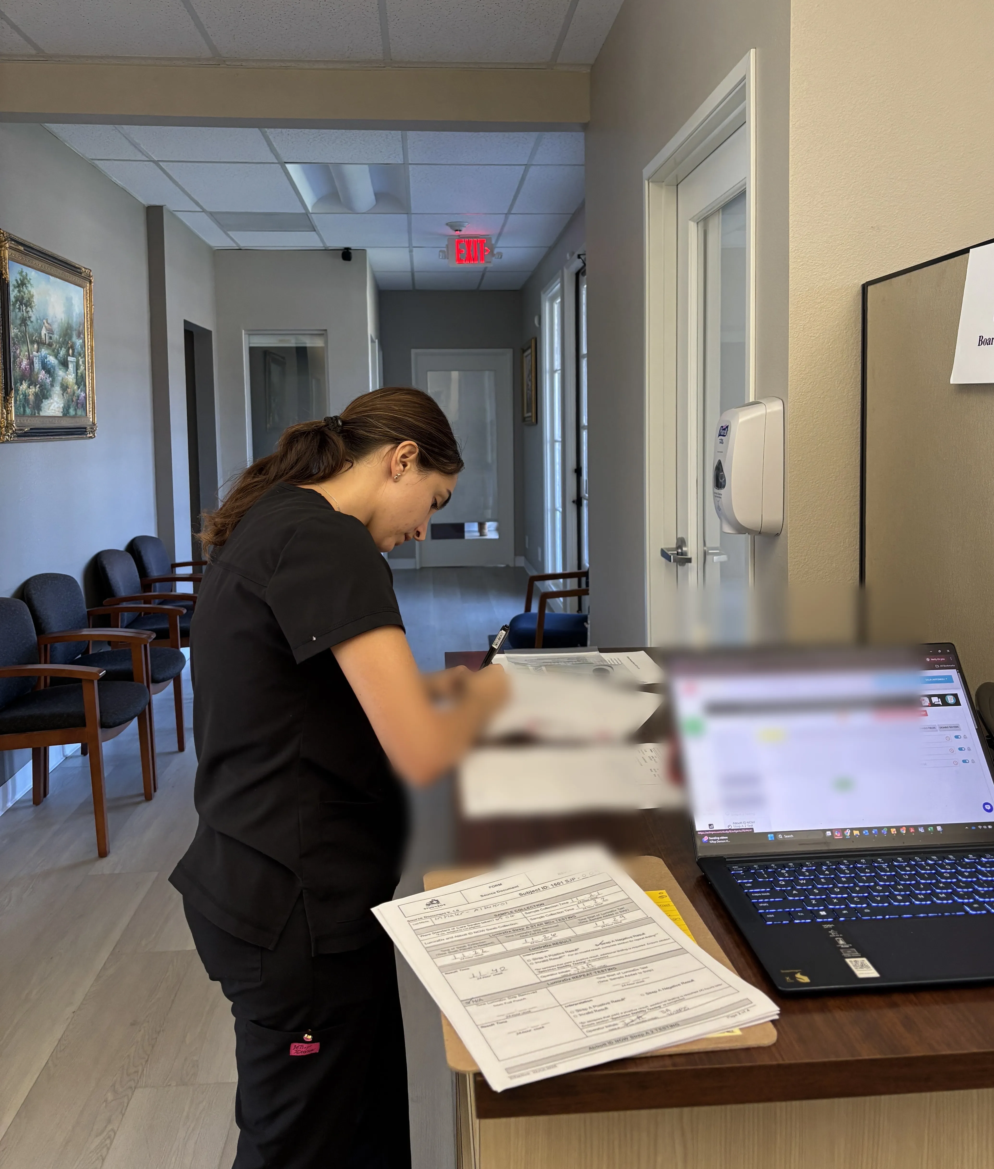 Studybox clinical research coordinator completing source documents at a partner clinic