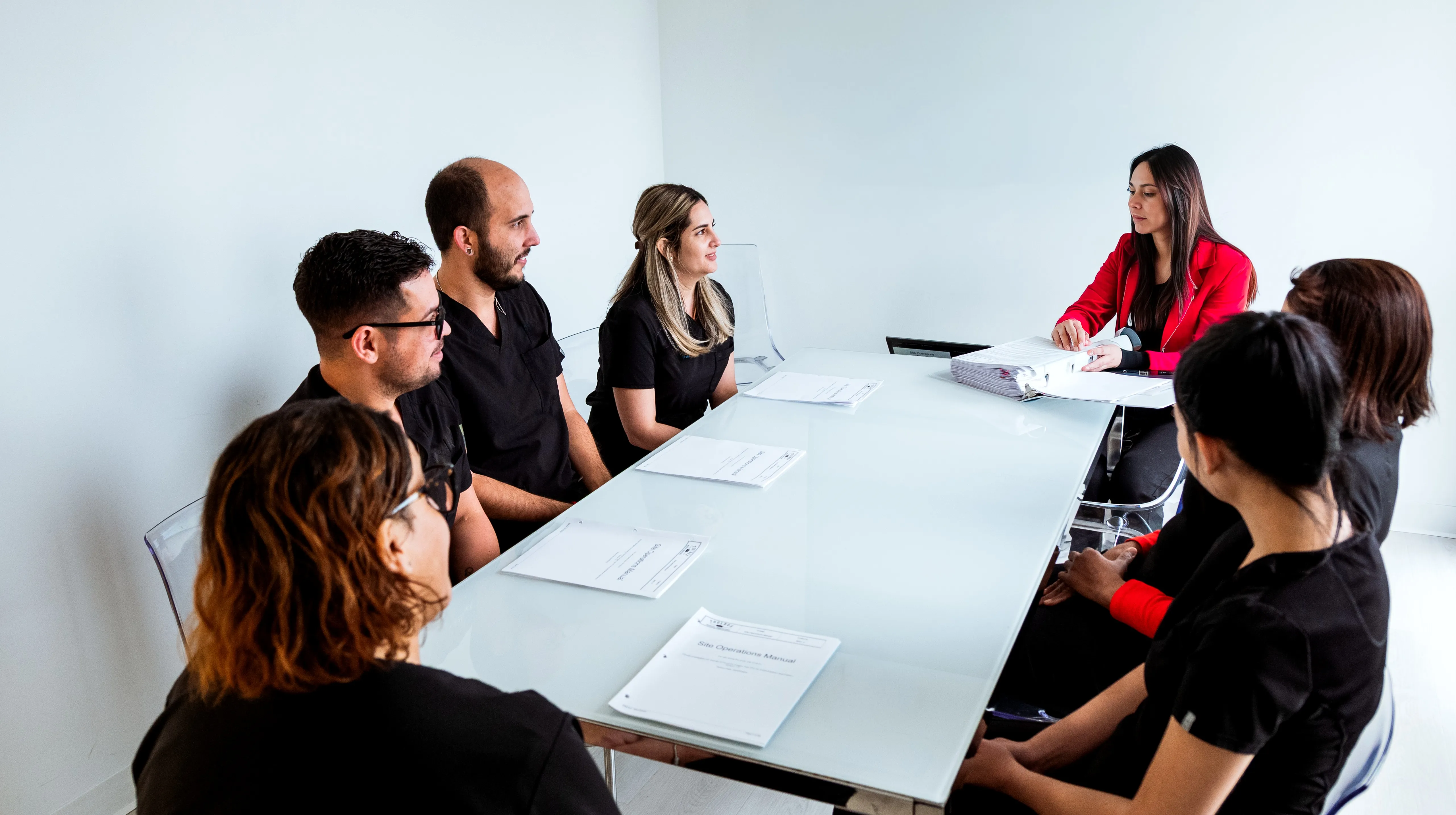Studybox team reviewing a Site Operations Manual in a planning meeting